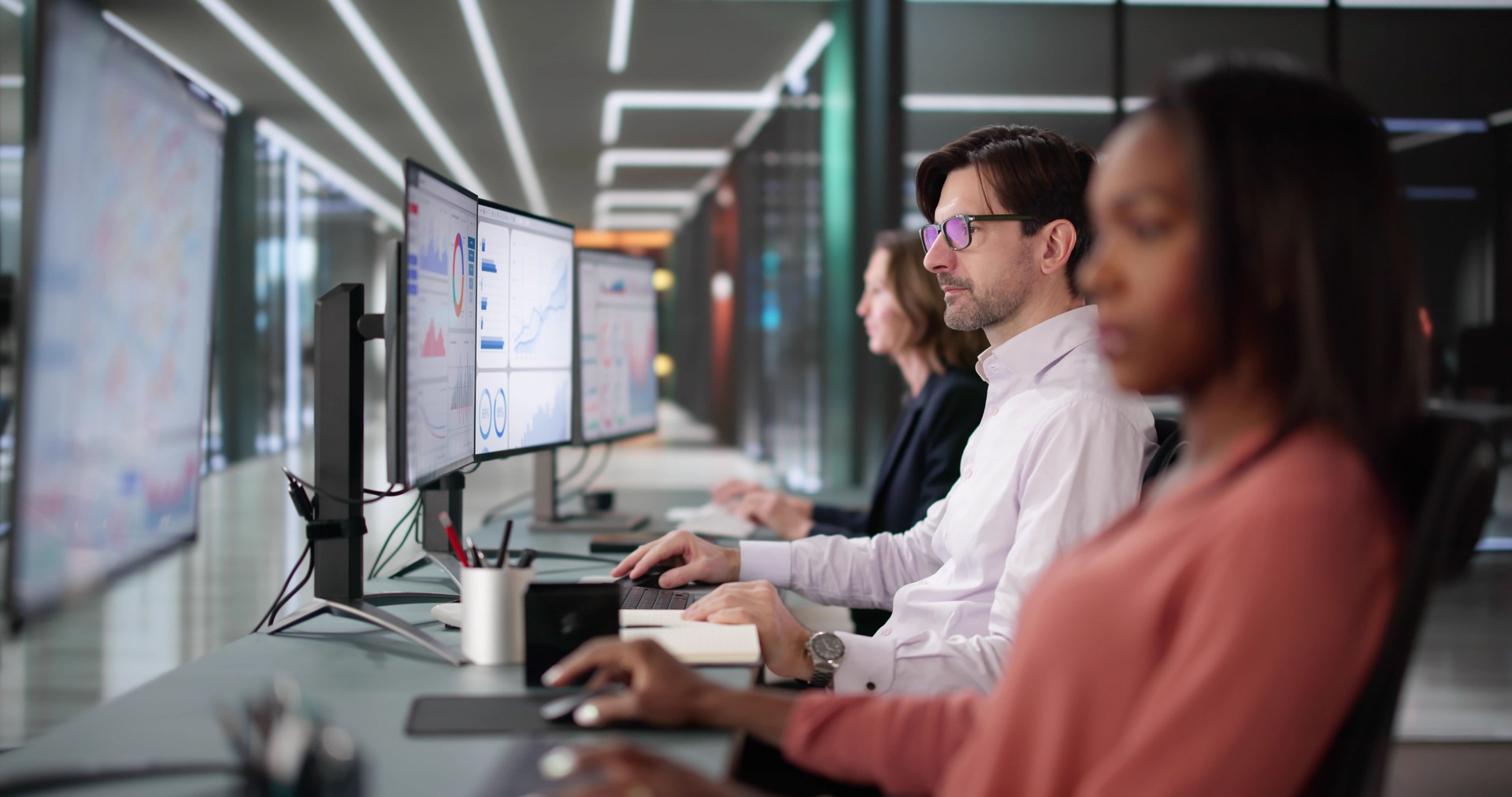 Diverse group of students and teachers analyzing business analytics